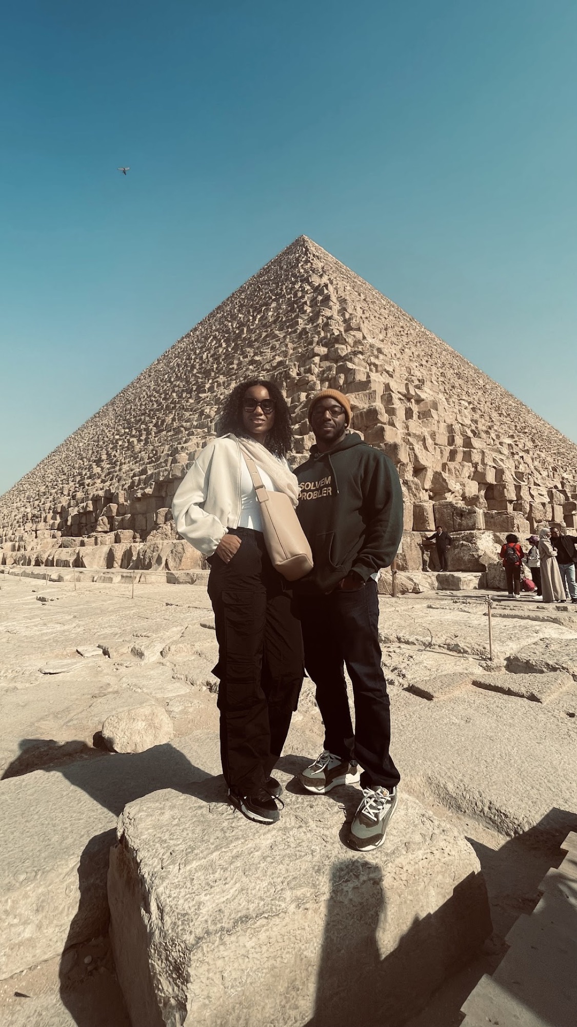 Kim and her husband at the Great Sphinx of Giza in warm afternoon light.